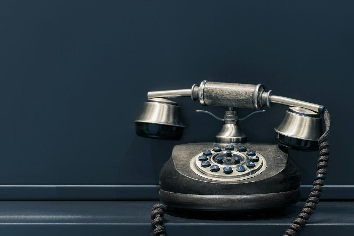 Telefonbuch-Eintrag löschen: altes Festnetztelefon vor dunkler Wand als Sinnbild für öffentlich gelistete Rufnummern